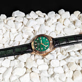 Malachite Watch Laying on stones Picture