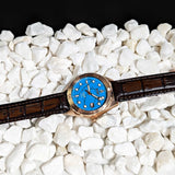 Turquoise Watch Laying on stones Picture