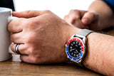 Aquacy Seiko Movement Watch Red And Blue On Wrist Holding Cup