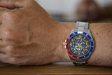 Aquacy Automatic Skeleton Watch Blue And Red On Wrist Holding Cup