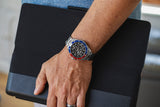 Aquacy Automatic Skeleton Watch Blue And Red On Wrist Standing