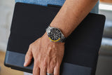 Aquacy Automatic Skeleton Watch Black And Yellow On Wrist Standing