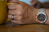 Aquacy Automatic Skeleton Watch Orange and Silver On Wrist Holding Cup